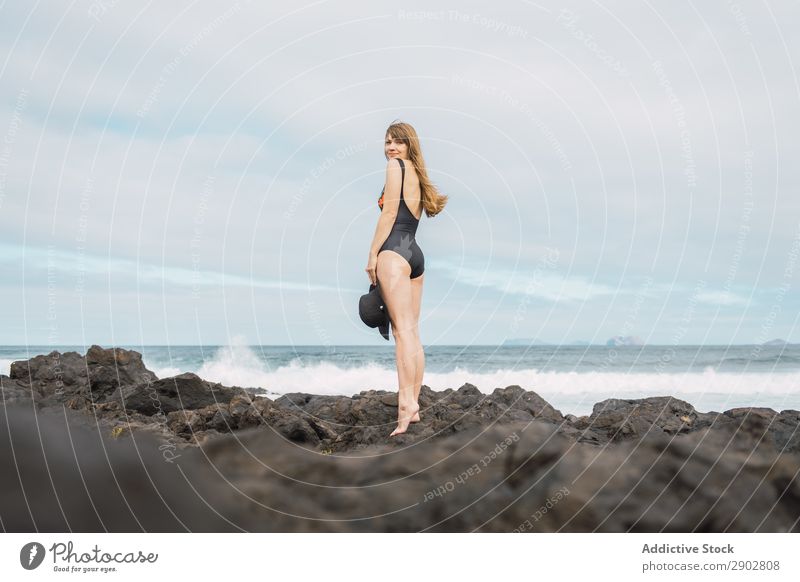 Sensual female near stormy sea Woman Ocean Coast Storm Swimwear Stand Lanzarote Spain Leisure and hobbies Waves Cloud cover Sky Weather To enjoy Swimsuit