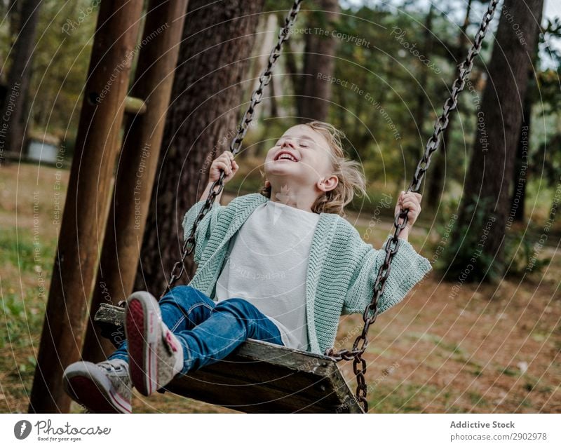 Smiling girl on swings in park Girl Forest Swing Park Child Positive Tree Nature Beautiful Woman Infancy Freedom Joy Wood Lifestyle Cheerful Fashion Garden