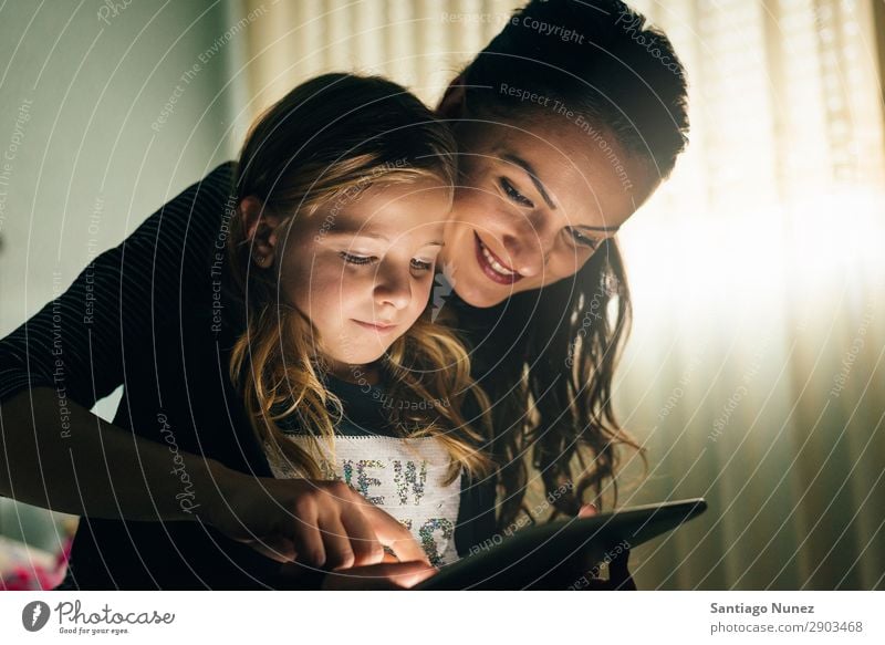 Mother and her child with digital tablet. Tablet computer Child Smiling Computer Playing Girl Family & Relations Education Small Daughter Son Together Digital