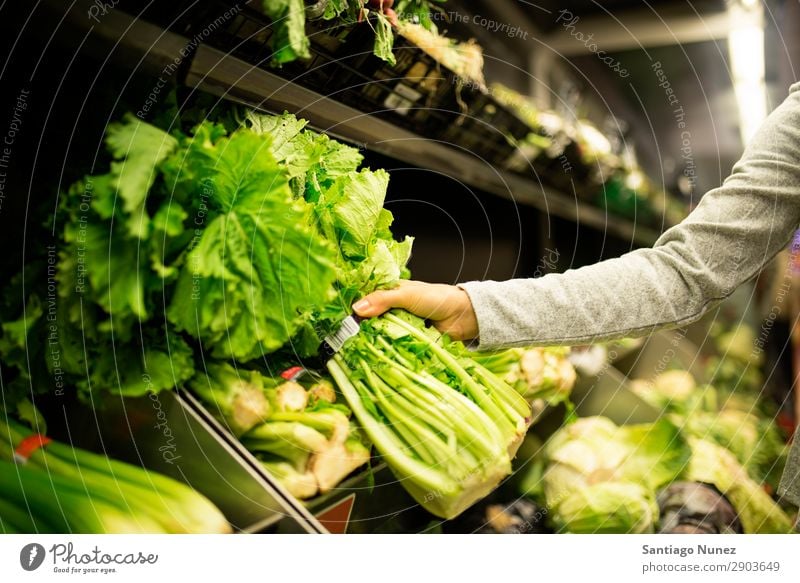 Close up of woman taking a lettuce in supermarket. Woman Shopping Supermarket Hand Take Close-up Food Markets using Human being Youth (Young adults) Smiling