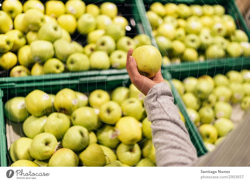 Beautiful woman choosing apples in supermarket. Fruit Supermarket Woman Close-up Storage Human being Apple Markets Food Hand Healthy Fresh Hold Shopping