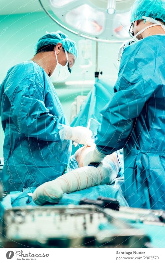 Team of Surgeons Operating in the Hospital. Operation Surgery operating surgical Room Doctor Theatre Medication Work and employment Group instrumental clinic