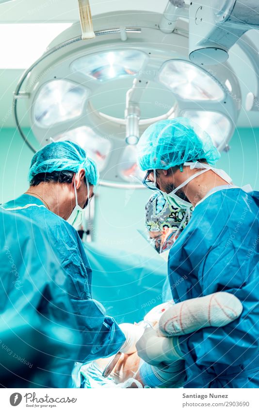 Team of Surgeons Operating in the Hospital. Operation Surgery operating surgical Room Doctor Theatre Medication Work and employment Group instrumental clinic