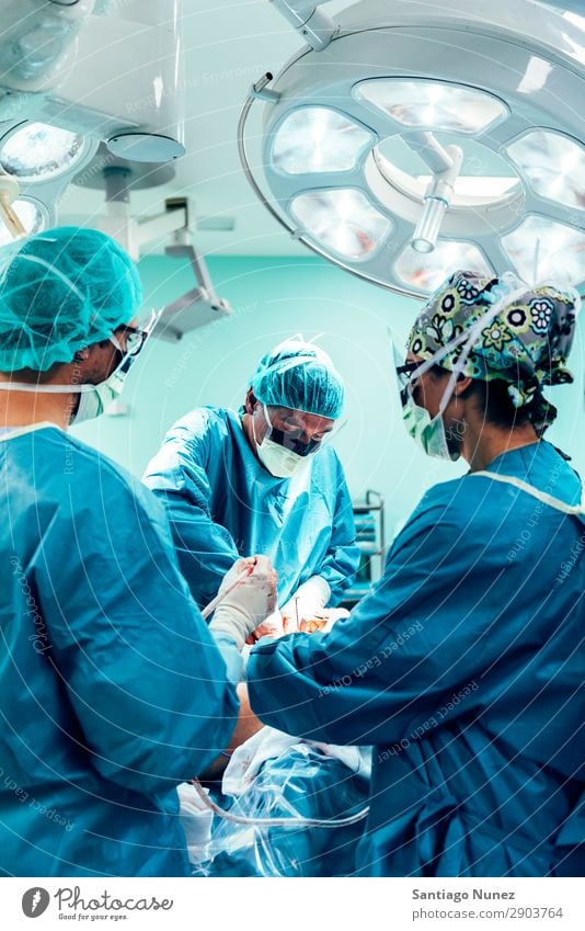 Team of Surgeons Operating Operation Surgery operating surgical Hospital Room Doctor Theatre Medication Work and employment Group instrumental clinic Man Woman