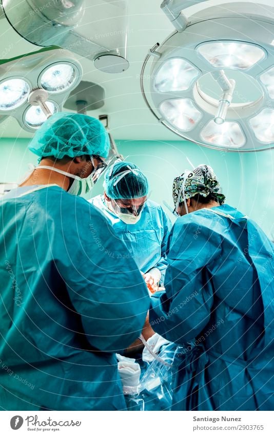 Team of Surgeons Operating Operation Surgery operating surgical Hospital Room Doctor Theatre Medication Work and employment Group instrumental clinic Man Woman