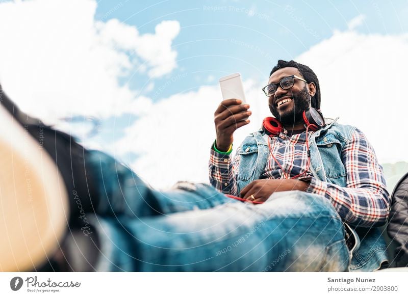 American man using mobile. Man Telephone Cellphone Town African Black Mobile Youth (Young adults) Laughter PDA Technology Human being Happy Happiness Smiling