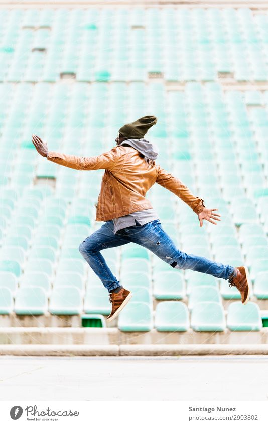 American man jumping in the park. Man Telephone Town Jump acting African Black Youth (Young adults) Human being Happy Happiness Smiling Laughter Cheerful