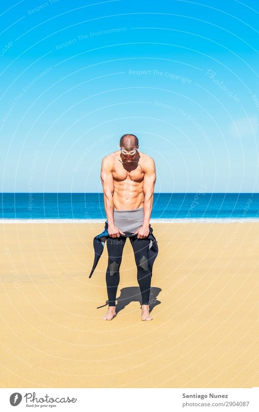 swimmer putting on his wetsuit on the beach abs Attractive Beach Black Body Caucasian Diver Practice Athletic Fitness Person wearing glasses Skiing goggles