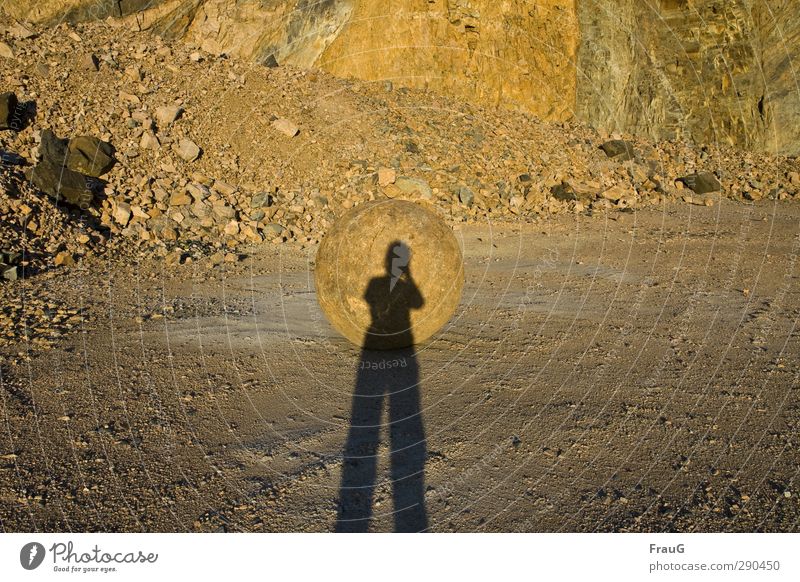 it looks like... Human being Feminine Woman Adults 1 45 - 60 years Summer Quarry Stone Sphere Illuminate Round Gold Moody Evening sun Sweden Colour photo
