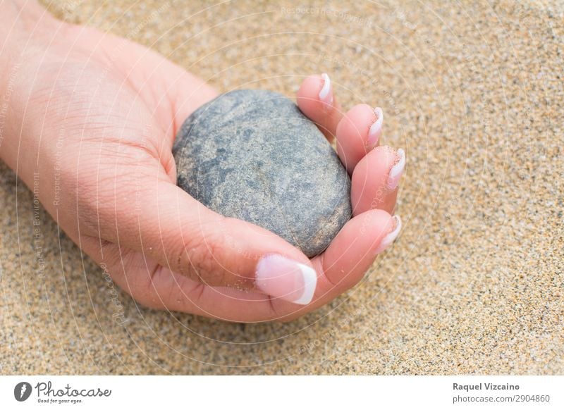 A woman holds a pebble in her hand. Health care Wellness Meditation Vacation & Travel Tourism Summer Summer vacation Beach Woman Adults Hand Sunlight Stone Sand