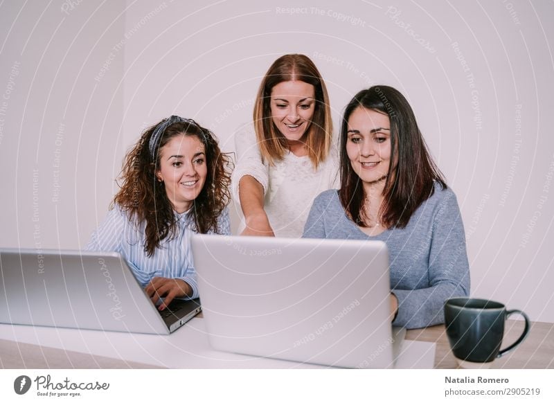 Three women are working in the office with their laptops Happy Desk Work and employment Profession Workplace Office Business To talk Computer Notebook