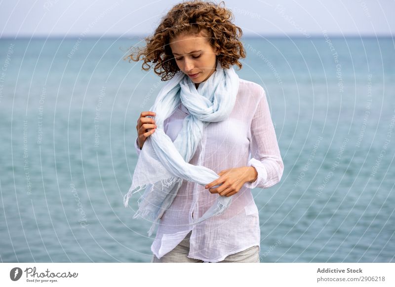 Young woman with sash near water Woman Water Scarf Attractive Surface upped hands Youth (Young adults) Charming Lifestyle Beach Curly Hair and hairstyles hairdo