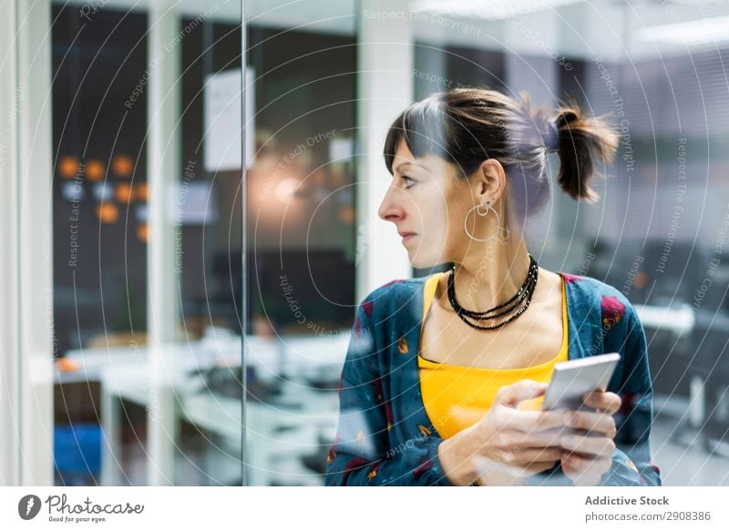 Woman browsing smartphone in office using PDA Office Glass Wall (building) Smiling Adults Modern Break Mobile Telephone Technology device Gadget Cheerful Joy