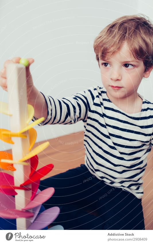Boy playing with wooden construction pieces Action Blonde Boy (child) Build Child Infancy Creativity Cute Education To enjoy Joy Happy Home indoor Marble