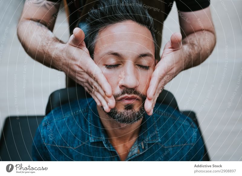 Barber doing face massage to handsome male - a Royalty Free Stock Photo  from Photocase