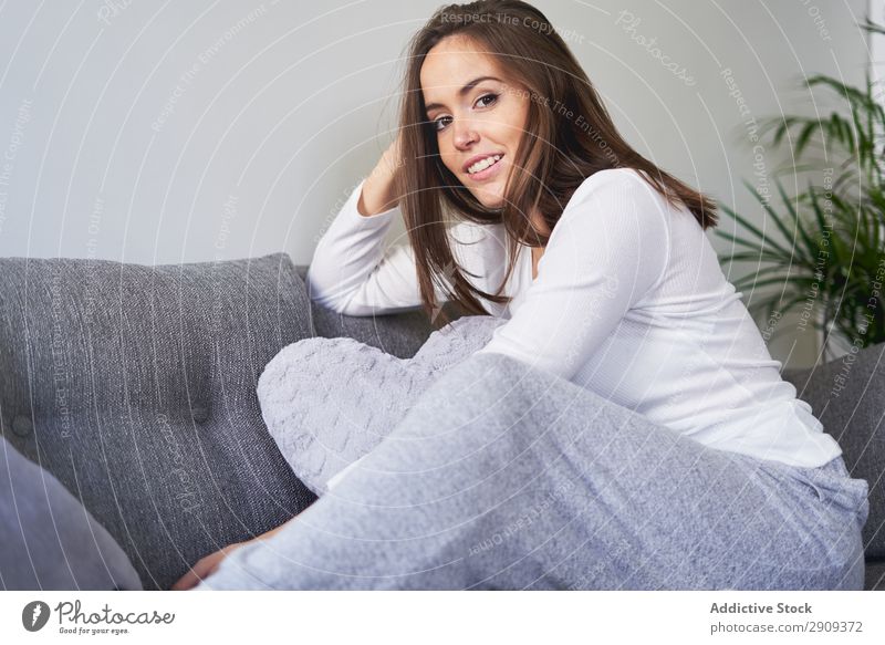 Smiling woman sitting on settee Woman Portrait photograph Home Settee Sit Resting Sofa Relaxation Happy Youth (Young adults) Attractive Volume knowledge