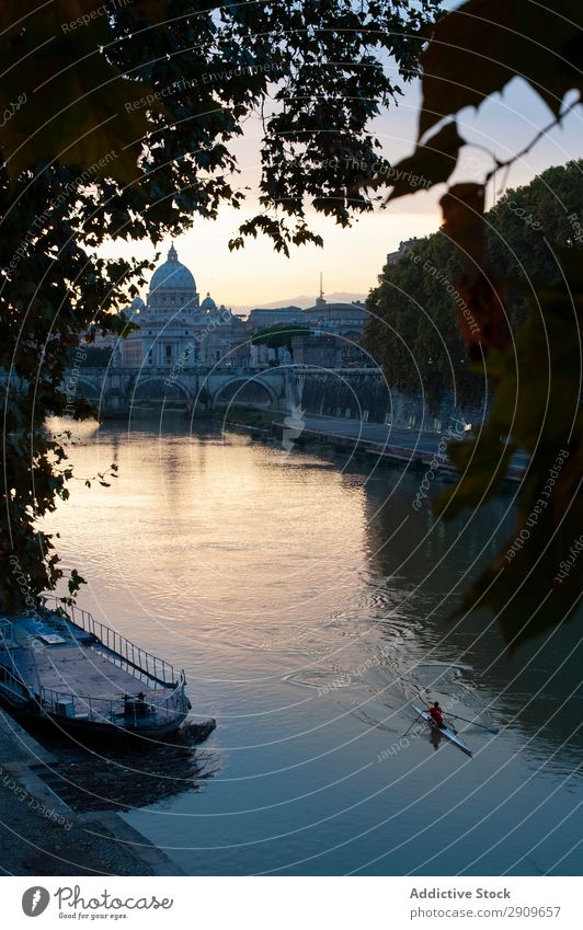 Person floating on boat towards bridge Human being Watercraft River Bridge Floating Sunset Evening ponte garibaldi Rome Vacation & Travel Trip Exterior Stream