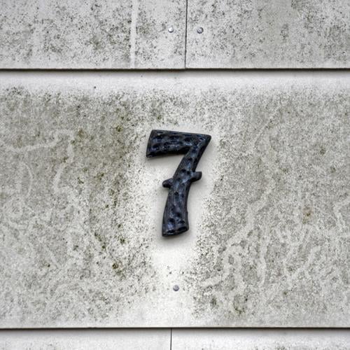 7 Sign Characters Signs and labeling Old Dirty Gray House (Residential Structure) House number Wall (building) Colour photo Subdued colour Exterior shot