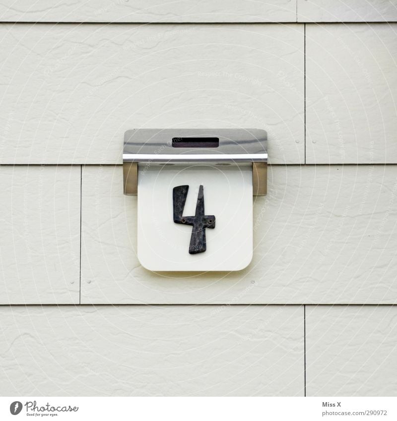 4 Sign Characters Signs and labeling Gray House number House (Residential Structure) Wall (building) Colour photo Exterior shot Close-up