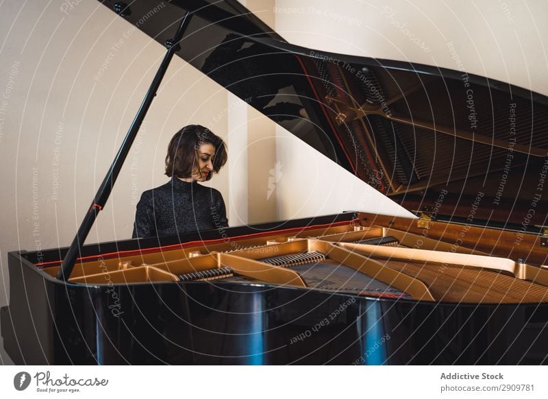 Young woman playing a piano at home Fiddle Playing Music Violinist Orchestra instrument Classical Musician Hand Musical Human being String Performance Bow