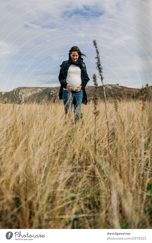 Pregnant woman looking her tummy in field Lifestyle Joy Happy Beautiful Leisure and hobbies Human being Baby Woman Adults Mother Family & Relations Nature