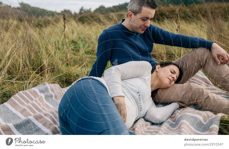 Man looking his pregnant woman resting on the grass Lifestyle Relaxation Human being Baby Woman Adults Father Family & Relations Couple Nature Landscape Autumn