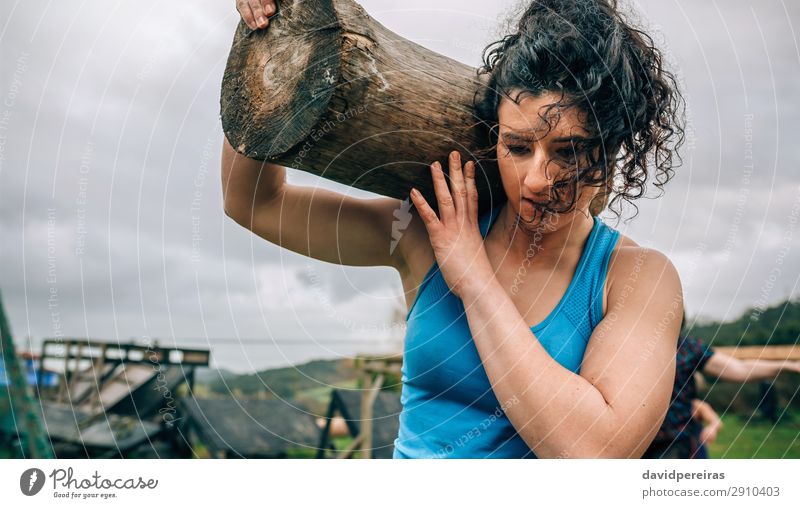 Female in an obstacle course carrying trunk Sports Human being Woman Adults Carrying Authentic Strong Power Effort Competition obstacle course race Tree trunk