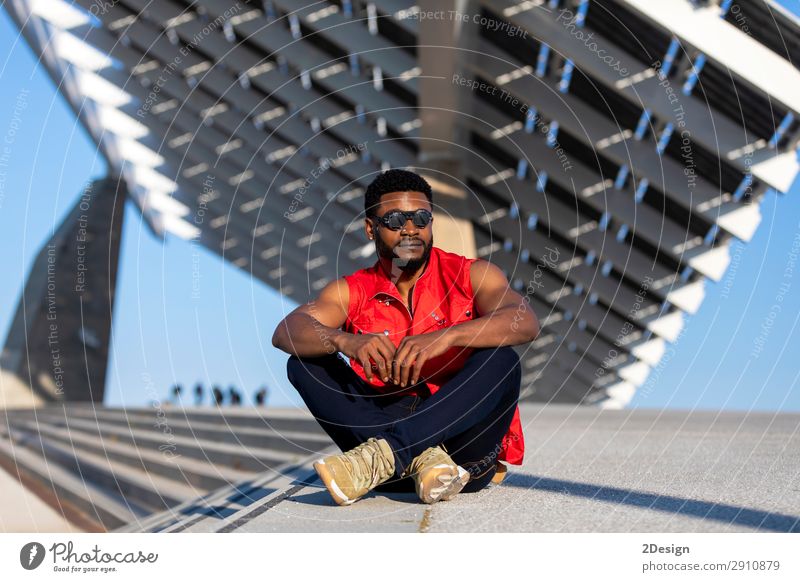 Young black man wearing sunglasses sitting on staircase - a Royalty Free  Stock Photo from Photocase