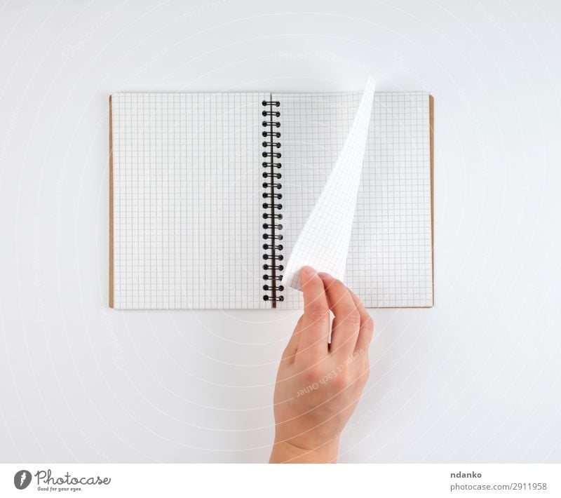 empty open notebook in a cell and a female hand Education School Study Office Business Human being Woman Adults Arm Hand Book Paper Pen Write White background