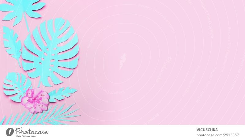 Turquoise tropical leaves and flowers background. Paper tropical leaves on pink background. Creative composing in pastel color with copy space for your design. Banner or template