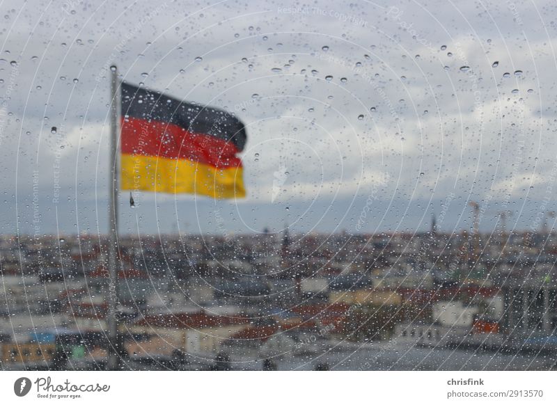German flag behind drops on glass pane in Berlin Clouds Rain Capital city Skyline Roof Glass Retro Gloomy Sadness Colour photo Interior shot Deserted