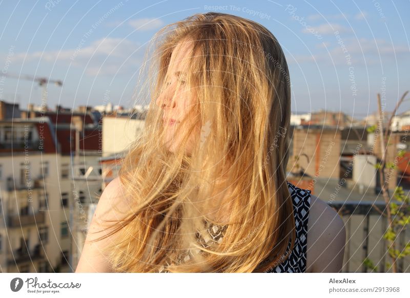 Blond girl with blowing hair on roof terrace Lifestyle Style Joy Beautiful Young woman Youth (Young adults) Hair and hairstyles 13 - 18 years Youth culture