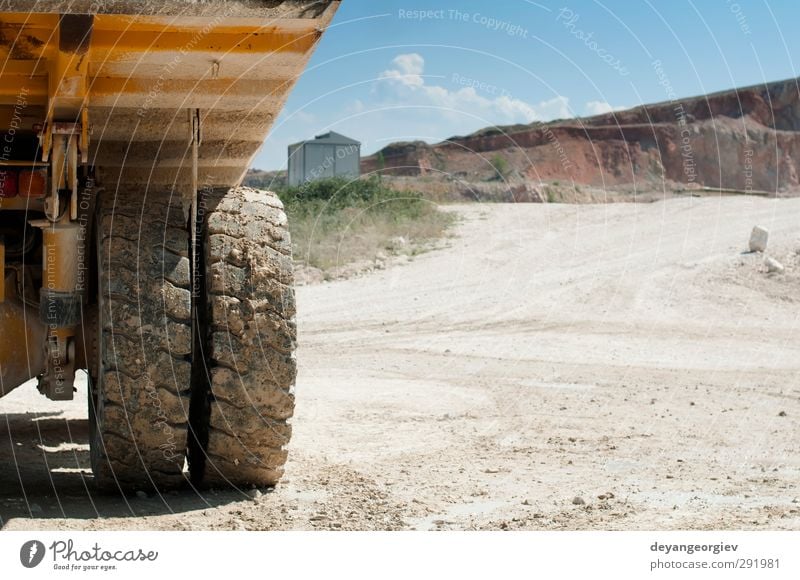Truck in the quarry. Close up tire and trailer Work and employment Industry Machinery Technology Sand Sky Rock Transport Vehicle Stone Steel Carrying Strong