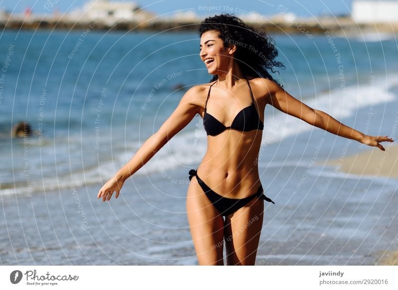 Young Arab woman in swimwear smiling on a tropical beach. Lifestyle Happy Beautiful Body Hair and hairstyles Skin Leisure and hobbies Vacation & Travel Tourism