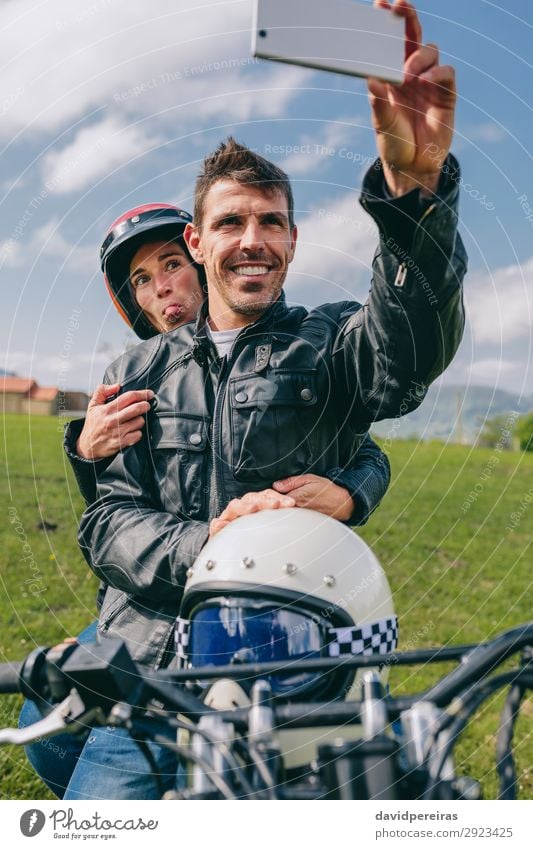 Couple taking a selfie on the motorcycle Lifestyle Joy Happy Vacation & Travel Trip PDA Human being Woman Adults Man Nature Grass Motorcycle Smiling Authentic