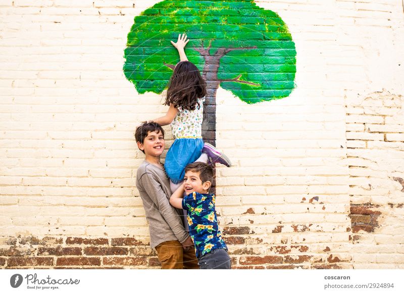 Three kids playing with a tree painted on a wall Lifestyle Joy Happy Beautiful Leisure and hobbies Playing Vacation & Travel Freedom Summer Garden Child School