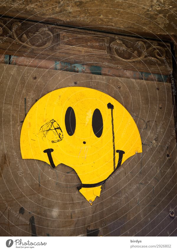 pitted Wall (barrier) Wall (building) Sign Smiley Emotion design Smiling Laughter Looking Authentic Brash Uniqueness Broken Positive Round Brown Yellow Joy