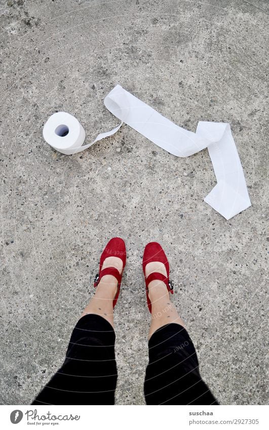 woman in the street with a roll of toilet paper Legs feet Woman Stand feminine High heels Street Asphalt Toilet paper toilet visit Priority Urgent Needs Clean