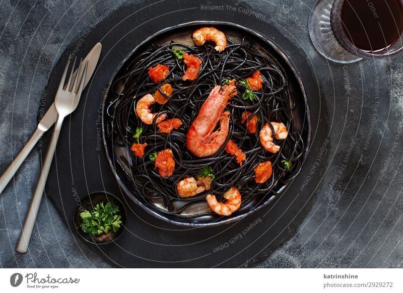 Squid ink pasta with prawns and tomatoes Seafood Eating Dinner Fork Wood Delicious Gray Black Spaghetti shrimp Tomato Rustic Italian Cooking Dish Parsley