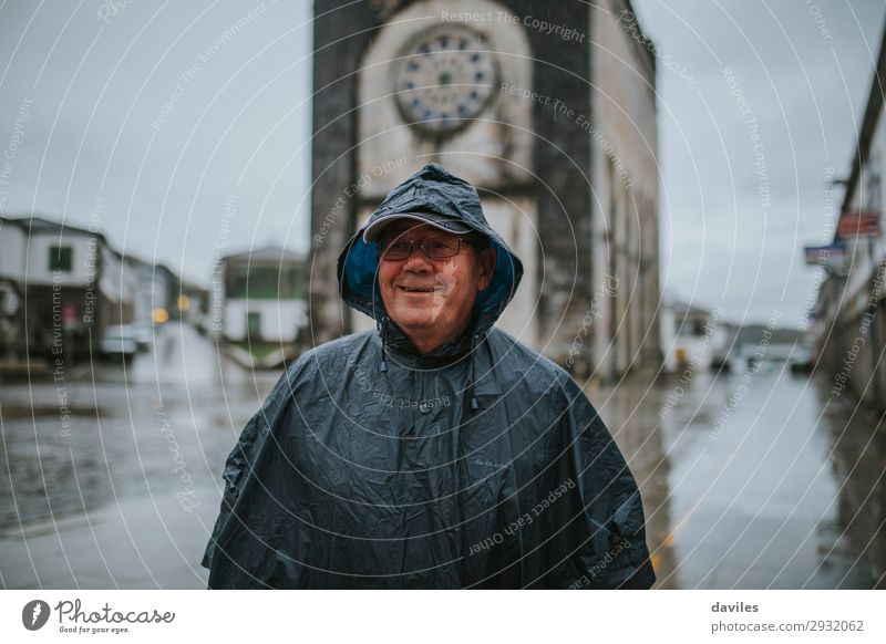 Smiling senior man wearing a rain coat Lifestyle Face Leisure and hobbies Tourism Adventure Hiking Human being Masculine Man Adults Father 1 60 years and older