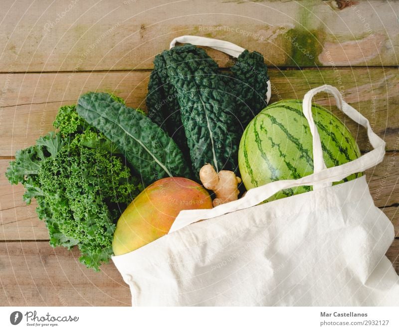 Cloth bag with vegetables on wooden background. Vegetable Fruit Nutrition Organic produce Vegetarian diet Diet Lifestyle Summer Table Kitchen Leaf