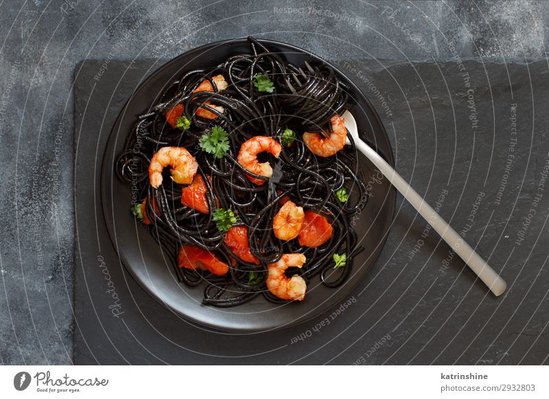 Squid ink pasta with prawns and tomatoes Seafood Eating Dinner Fork Delicious Black Spaghetti shrimp Tomato Italian Cooking Dish Parsley Portion knife Slate