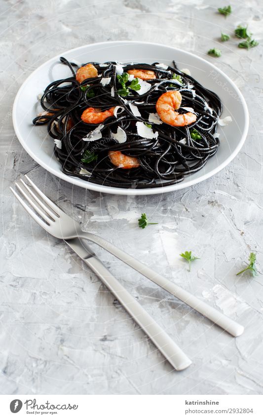 Squid ink pasta with prawns and tomatoes Seafood Eating Dinner Delicious Modern Gray Black Spaghetti shrimp Tomato Rustic Italian Cooking Dish Parsley Portion