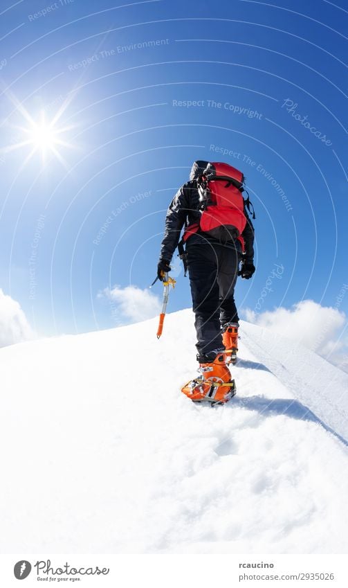 A climber reaching the summit of a snowy mountain Joy Vacation & Travel Adventure Freedom Expedition Winter Snow Mountain Sports Climbing Mountaineering Success