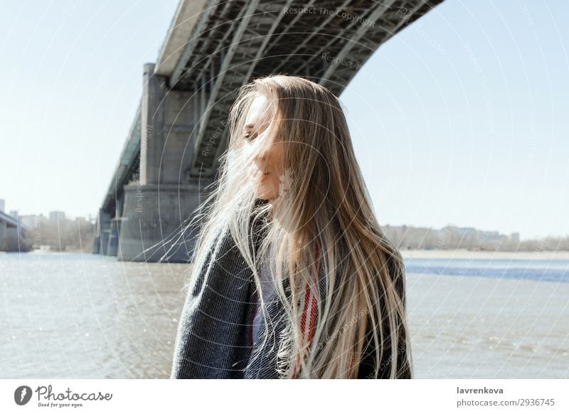 portrait of female on a beach with flying hair Vacation & Travel Blonde City Bridge Beach Cold Hair Weather Scarf Coat Spring Lifestyle Summer Ocean Young woman