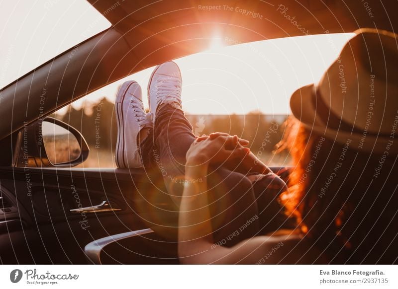 Modern girl resting in a car at sunset Lifestyle Joy Relaxation Vacation & Travel Trip Adventure Summer Sun Feminine Young woman Youth (Young adults) Woman