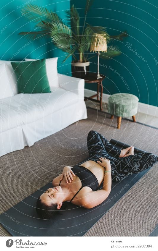 young woman relaxing by doing yoga in living room Lifestyle Happy Beautiful Body Wellness Meditation House (Residential Structure) Living room Sports Yoga