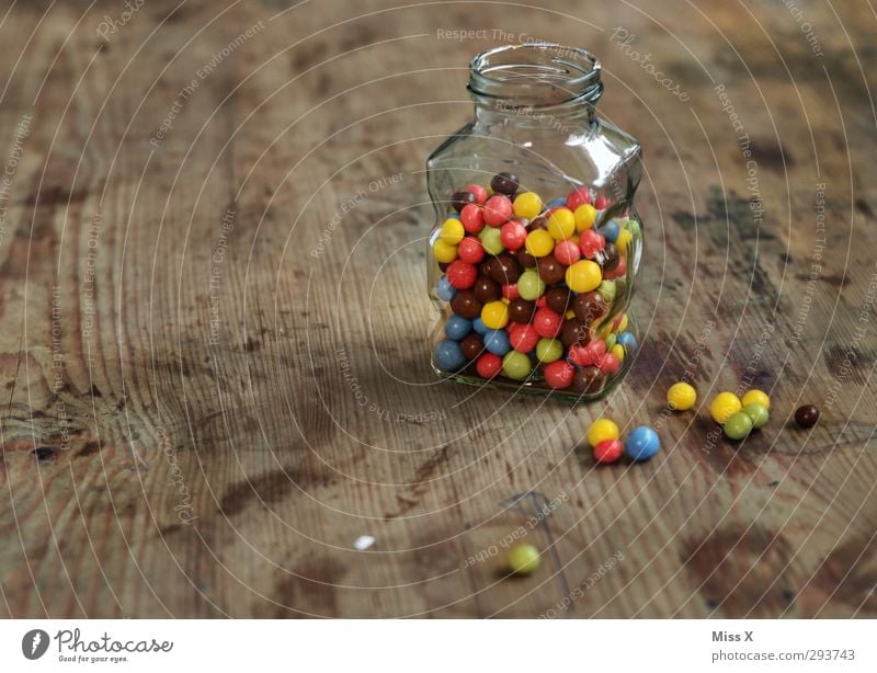candy jar Food Candy Chocolate Nutrition Small Delicious Round Sweet Multicoloured Chocolate buttons Wooden table Glass Containers and vessels Keep Ingredients