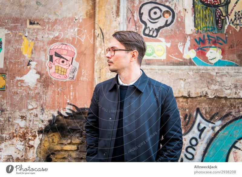 Portrait of a young man in front of a wall Italy Rome Wall (building) Portrait photograph Young man Street art Coat Profile Look back Looking