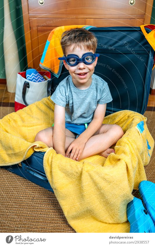 Funny boy smiling sitting inside a suitcase Lifestyle Joy Happy Swimming pool Leisure and hobbies Vacation & Travel Trip Summer Beach Child Human being